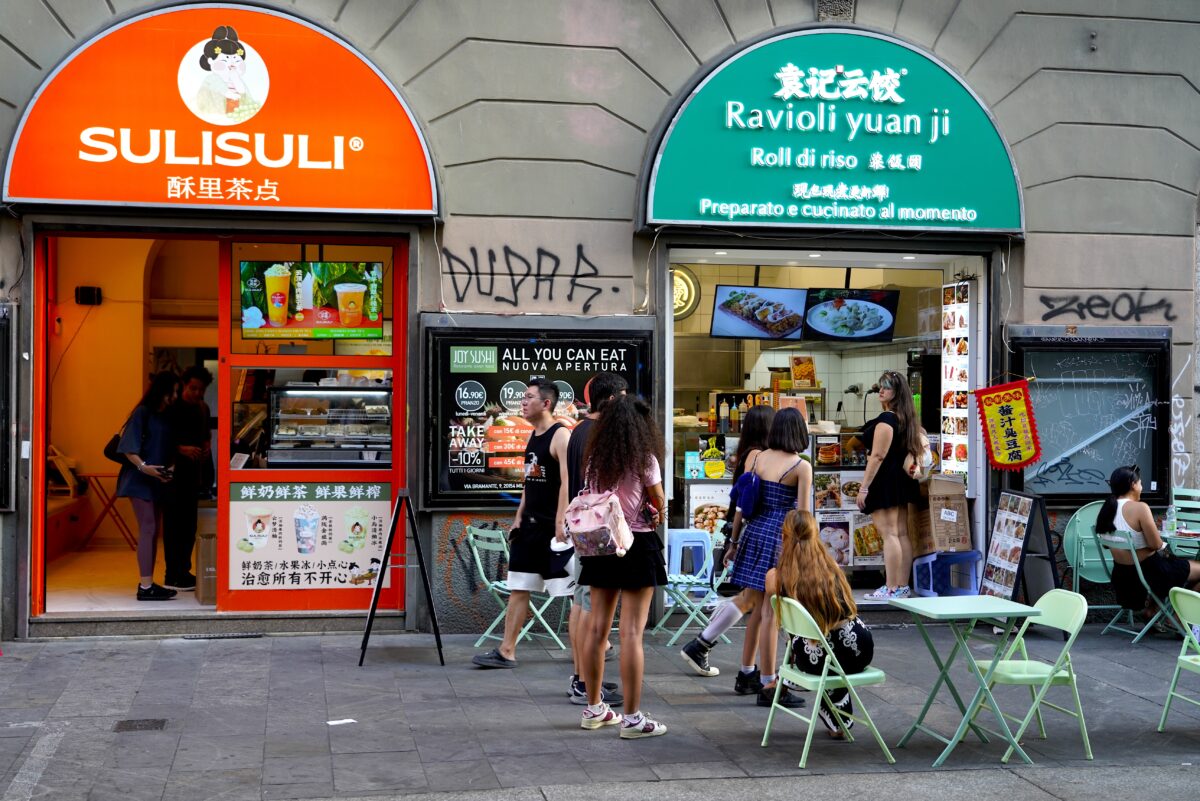 Young shoppers buying Chinese food in Milan's Chinatown