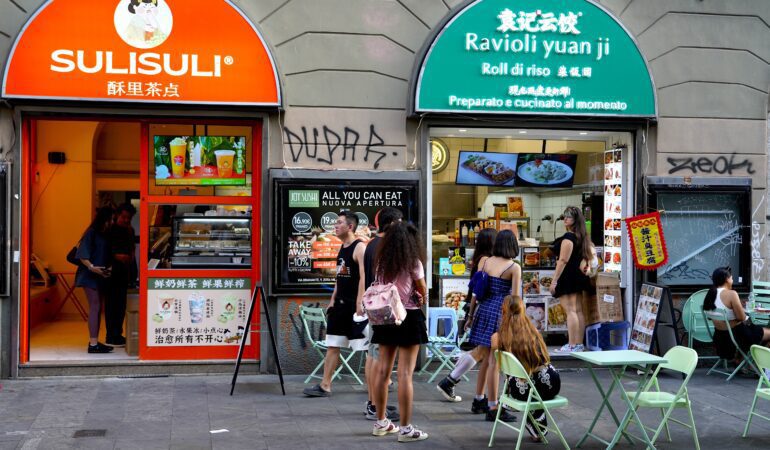 Young shoppers buying Chinese food in Milan's Chinatown